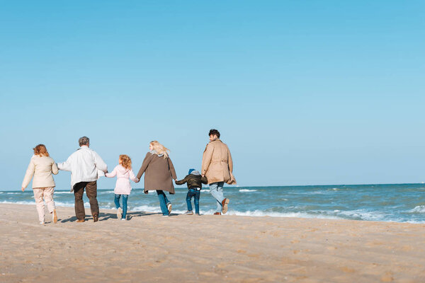 family walking at seashore