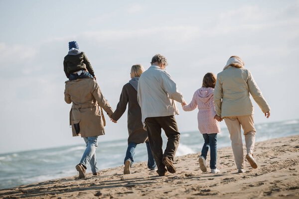 multigenerational family together on seashore