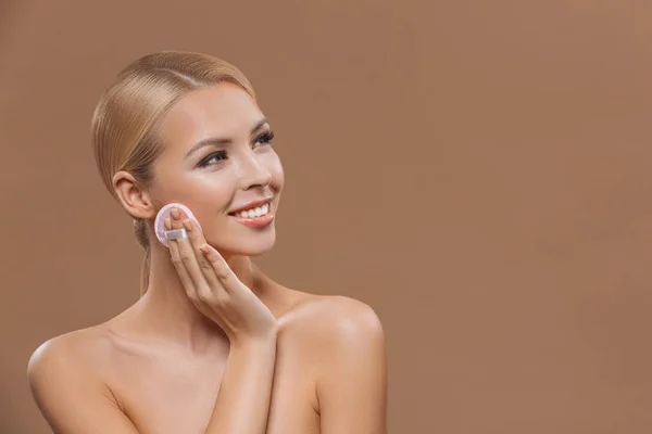 Нанесение макияжа с косметической губкой — стоковое фото
