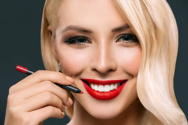 Όμορφη Χαμογελαστή Γυναίκα Κάνει Κόκκινα Χείλη Καλλυντικά Μολύβι Απομονώνονται Γκρι — Φωτογραφία Αρχείου