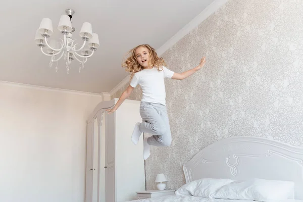 Smiling Child Jumping Bed Looking Camera — Stock Photo, Image