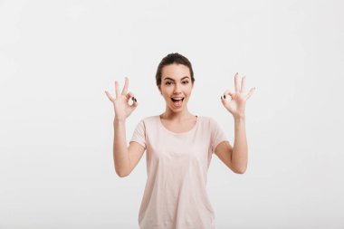 happy girl showing ok gesture with two hands isolated on white clipart