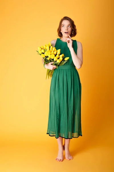 Pensive Young Woman Green Dress Bouquet Yellow Tulips Looking Away — Stock Photo, Image