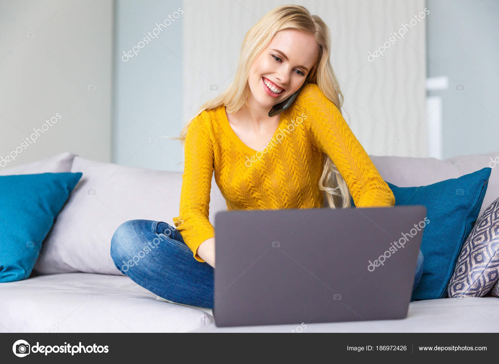 Beautiful Smiling Young Blonde Woman Using Laptop Talking Smartphone ...