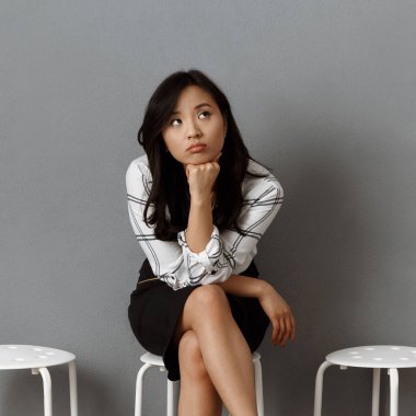 pensive asian businesswoman waiting for job interview clipart