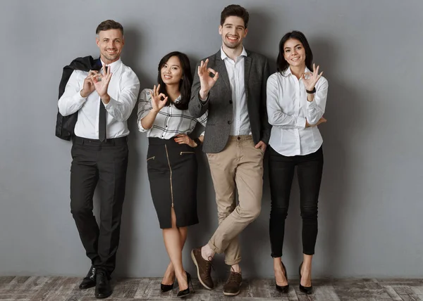 Multicultural Business People Formal Wear Showing Sign While Standing Grey — Stock Photo, Image