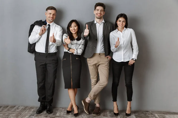 Multicultural Business People Formal Wear Showing Thumbs While Standing Grey — Stock Photo, Image