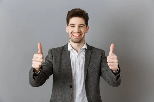 Portrait Smiling Businessman Suit Showing Thumbs Grey Wall — Stock Photo, Image