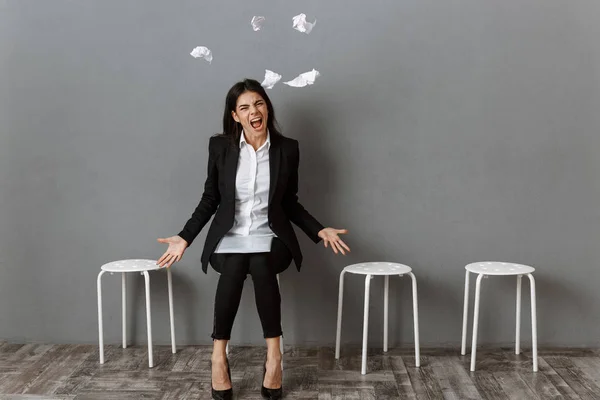 Angry and stressed businesswoman in suit with wrapped papers waiting for job interview — Stock Photo