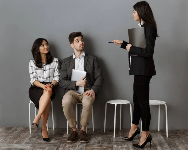 Empresaria con carpeta la elección de colega para la entrevista de trabajo - foto de stock