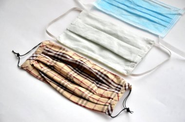 Beyaz arka planda üç cerrahi maske