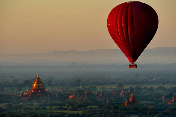 Bagan. Myanmar. 11/25/2016. Every morning at dawn, a dozen balloons carrying tourists rise together into the sky to see a bird\'s eye splendour of many ancient Buddhist temples of Bagan.