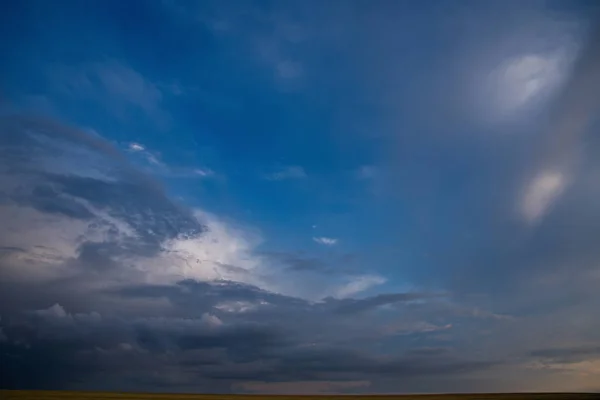 Russia. Evening sky over the endless fields of Altai. Colors of summer sunset