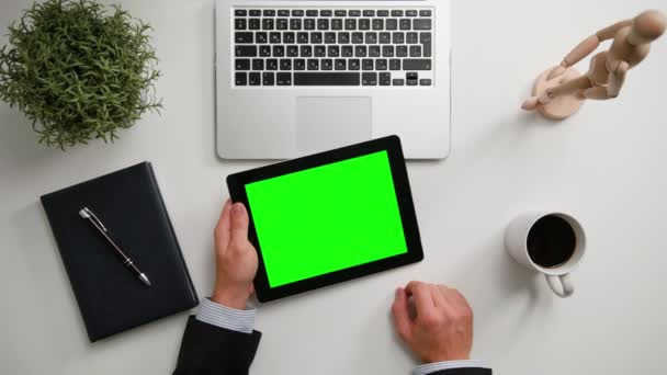 Руки-манипуляторы держат i-Pad с зеленым экраном — стоковое видео