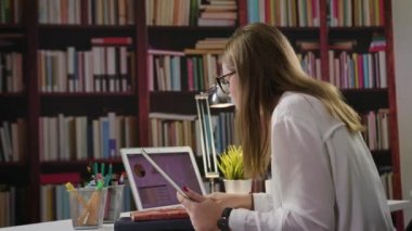 Bir dizüstü bilgisayar ve bir Tablet kütüphanede kullanarak bir Bayan