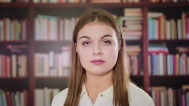 Kütüphanede gülümseyen güzel bir sarışın kadın