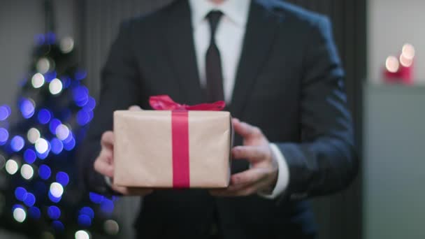 Επανδρώνει τα χέρια κρατώντας ένα χριστουγεννιάτικο δώρο — Αρχείο Βίντεο
