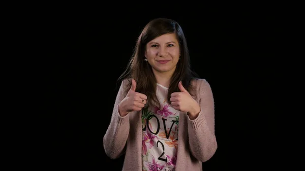 A Lady with Thumbs Up Against a Black Background — Stok Foto