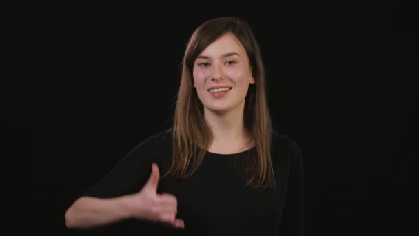 A Lady Mimicing Against a Black Background — Stock Video