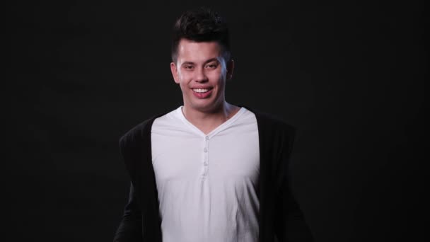 A Young Man Mimicing Against a Black Background — Stok Video