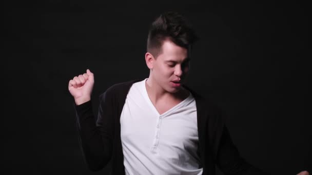 A Young Man Dancing Against a Black Background — Stock Video