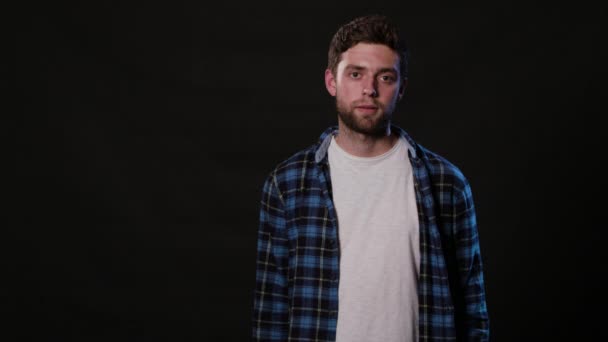 A Young Man Mimicing Against a Black Background — Stock Video