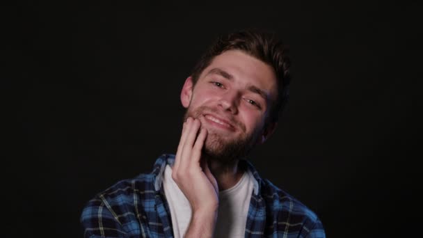 A Man Touching his Beard Against a Black Background — Stock Video