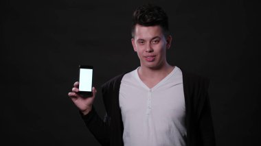 Bir adam bir telefon siyah bir arka planda tutarak