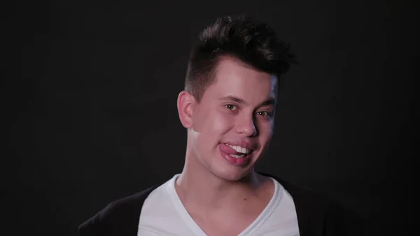 Man Biting his Tongue Against a Black Background — Stock Photo, Image