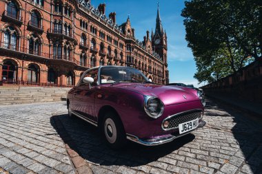London / UK - 05/21/2020: London's busy area, popular destination empty as people self isolate during. Nissan Figaro parked next to St Pancras Station clipart