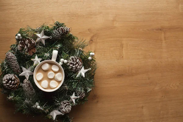 Christmas wreath with cup of hot cocoa and marshmallo