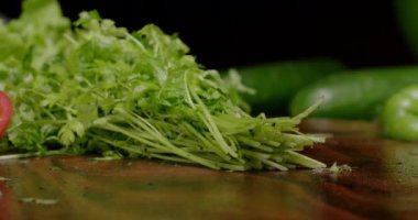 Cutting greens with kitchen knife for cooking healthy food.