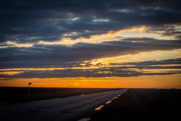 25 March 2017, Russia, Volgograd-Astrakhan road. Spring cloudy sunset on the road.