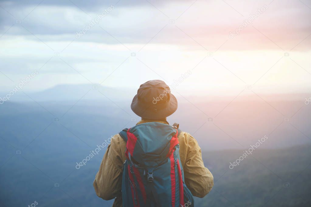 close up backpack man hiking traveling on forest in travel Lifestyle wanderlust adventure with enjoying on nature. Tourist traveler on background valley landscape view.