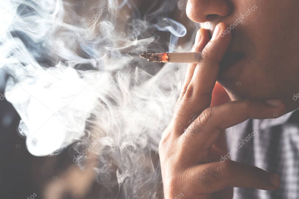 Man is smoking, harmful to health