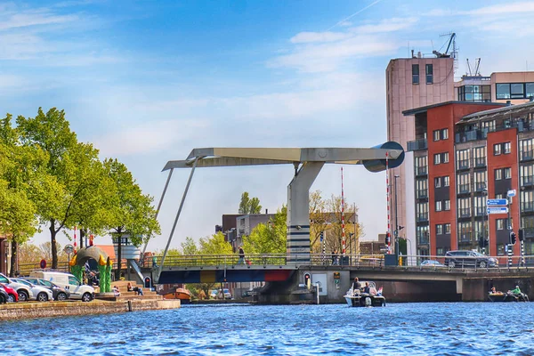 HAARLEM, NETHERLANDS - APR 30, 2017 : Modern drawbridge over the canal. Typical Dutch architecture. View from the boat level. — Stock Photo, Image