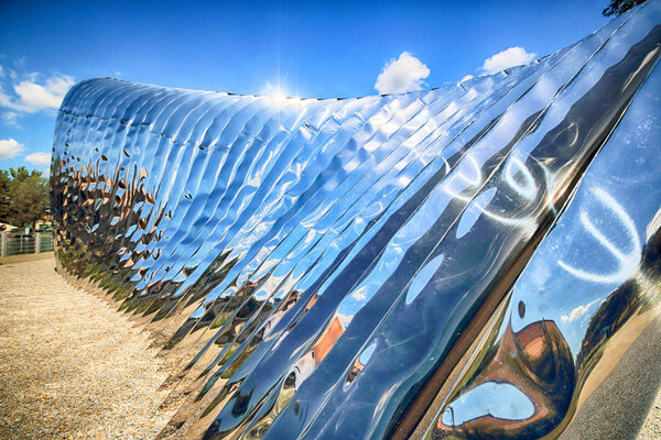 WROCLAW, POLAND - JULY 29, 2017: The NAWA sculpture designed by Oskar Zieta, erected on Daliowa Island. Due to polished steel surface NAWA reflects its surroundings (different feeling every time).