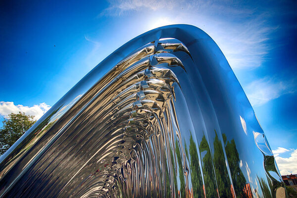 WROCLAW, POLAND - JULY 29, 2017: The NAWA sculpture designed by Oskar Zieta, erected on Daliowa Island. Due to polished steel surface NAWA reflects its surroundings (different feeling every time).