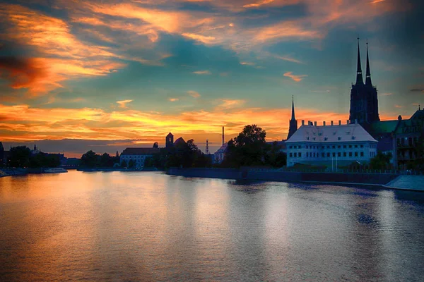 WROCLAW, POLONIA - 8 de agosto de 2017: Ciudad Vieja de Wroclaw. La Isla Catedral (Ostrow Tumski) es la parte más antigua de la ciudad. Río Odra, barcos y edificios históricos durante el hermoso atardecer . — Foto de Stock