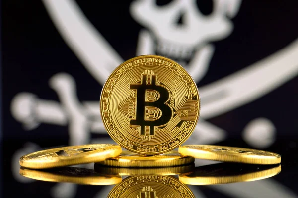 Physical version of Bitcoin (new virtual money) and Pirate Flag. Conceptual image for investors in cryptocurrency and Blockchain Technology. Risk, safety and security. — Stock Photo, Image