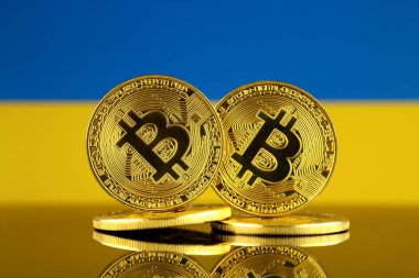 Bitcoin ve Ukrayna bayrağı fiziksel sürümü. Yakın çekim.