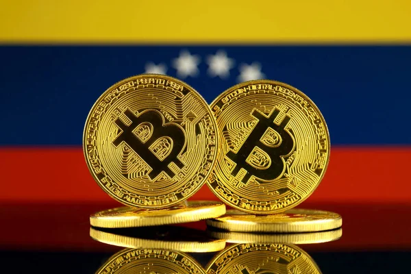 Physical version of Bitcoin and Venezuela Flag. Close up.