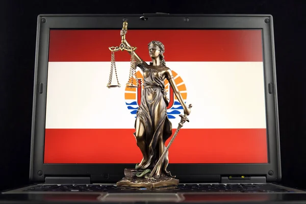 Symbol of law and justice with French Polynesia Flag on laptop. Studio shot.