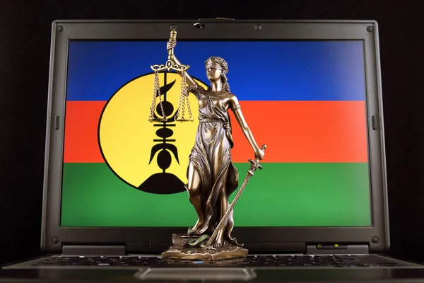 Symbol of law and justice with New Caledonia Flag on laptop. Studio shot.