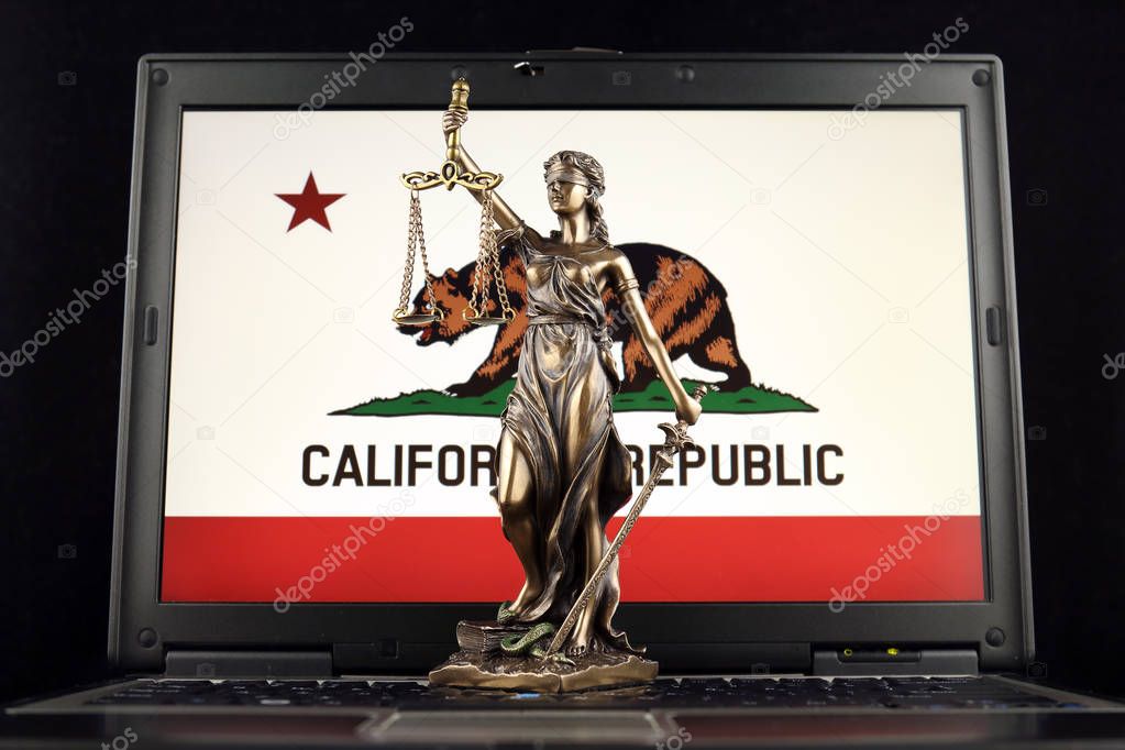 Symbol of law and justice with California State Flag on laptop. Studio shot.