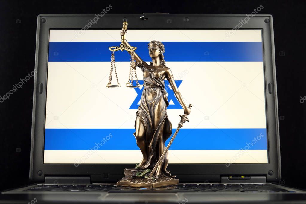 Symbol of law and justice with Israel Flag on laptop. Studio shot.