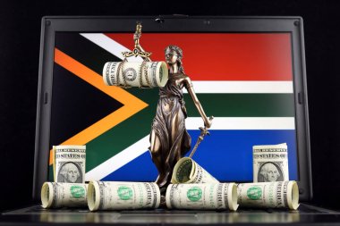Symbol of law and justice, banknotes of one dollar and South Africa Flag on laptop. Studio shot. clipart
