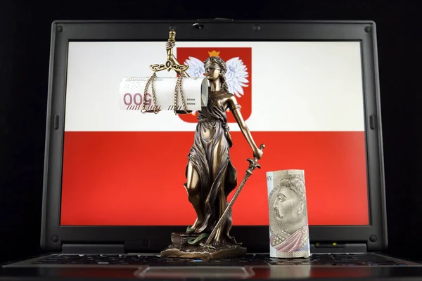 Symbol of law and justice, polish zloty banknotes and Poland Flag on laptop. Studio shot.