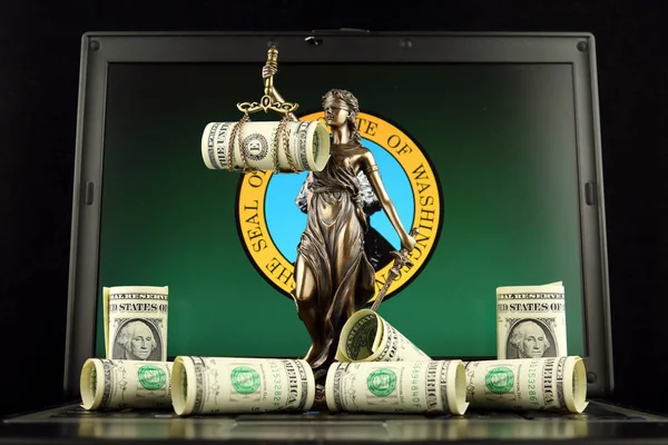 Symbol of law and justice, banknotes of one dollar and Washington State Flag on laptop. Studio shot.