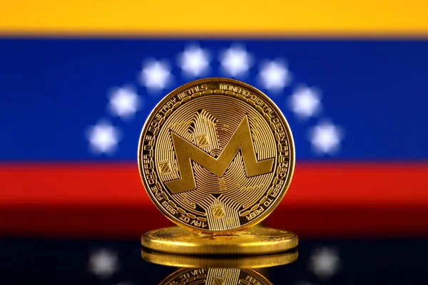 Physical version of Monero (XMR), new virtual money and Venezuela Flag. Conceptual image for worldwide cryptocurrency and digital payment system. Studio shot.